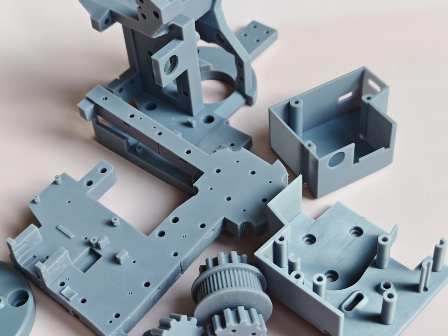Grey resin mechanical parts including housings, gears and small lever components