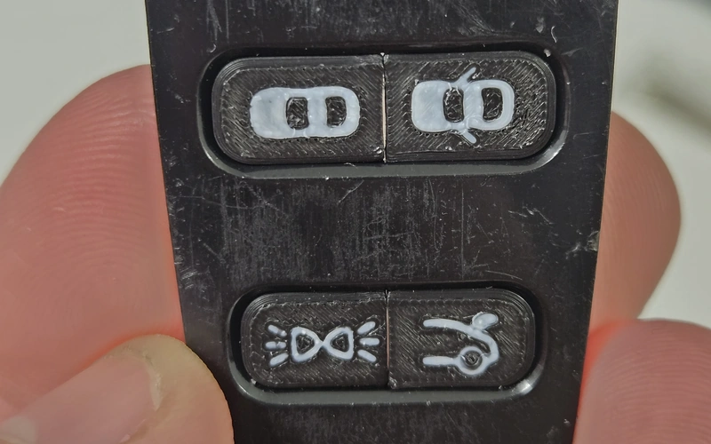 Close-up of replacement key buttons installed in a key fob.