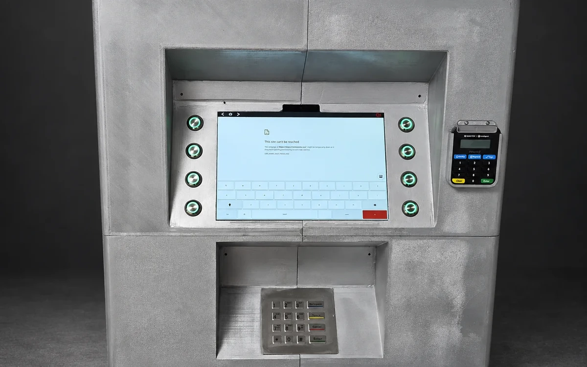 Assembled kiosk with a fitted tablet, illuminated green buttons and a metal keypad.