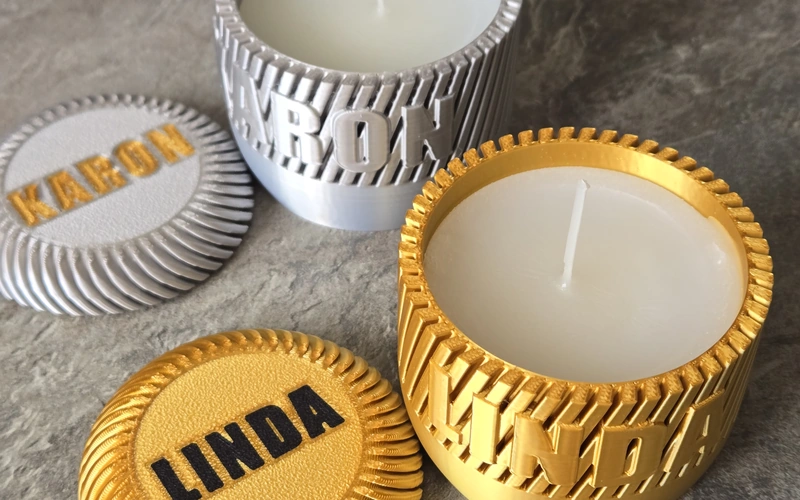 Personalised 3D printed candle jars with raised lettering and custom lids.
