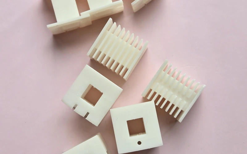 A set of small resin-printed coil bobbins with core openings.